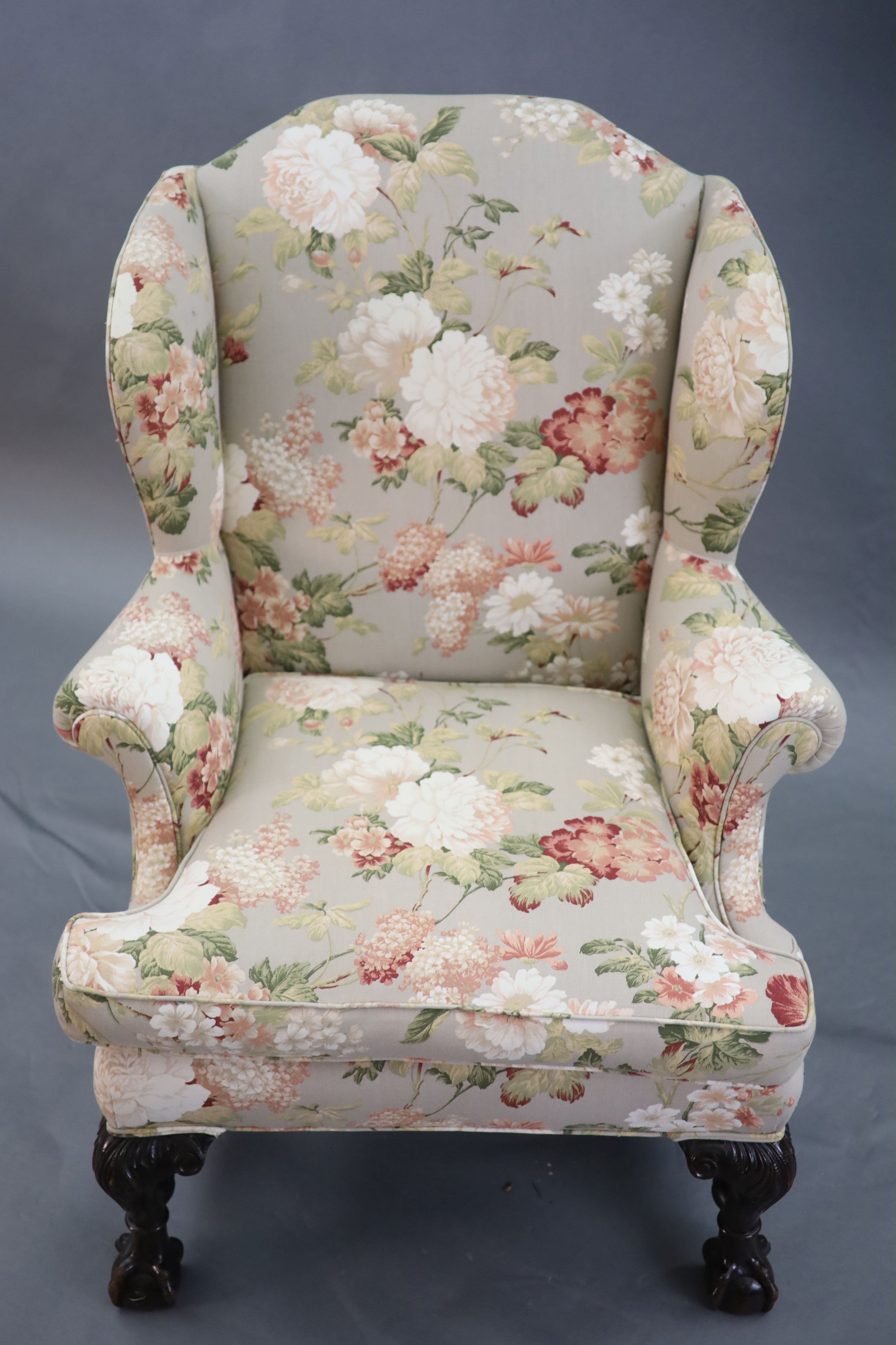 A Chippendale revival wing armchair together with a matching contemporary footstool